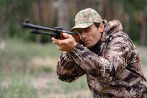 Young Man is Aiming with Shotgun Rabbit Hunt.
